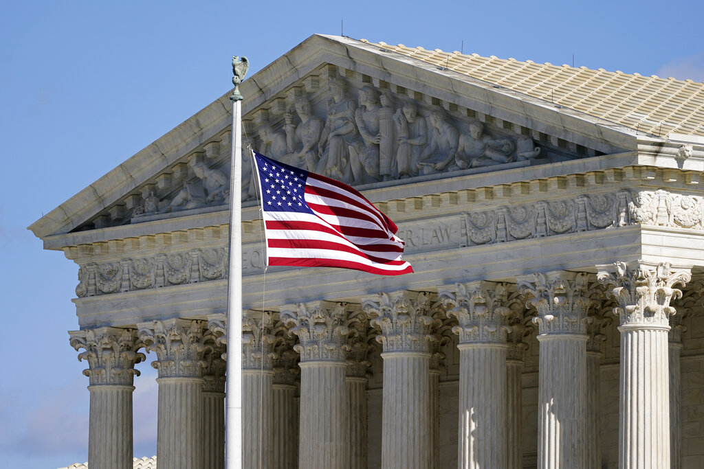 In this Nov. 2, 2020, file photo an American flag waves in front of the Supreme Court building on Capitol Hill in Washington. (AP Photo/Patrick Semansky, File)