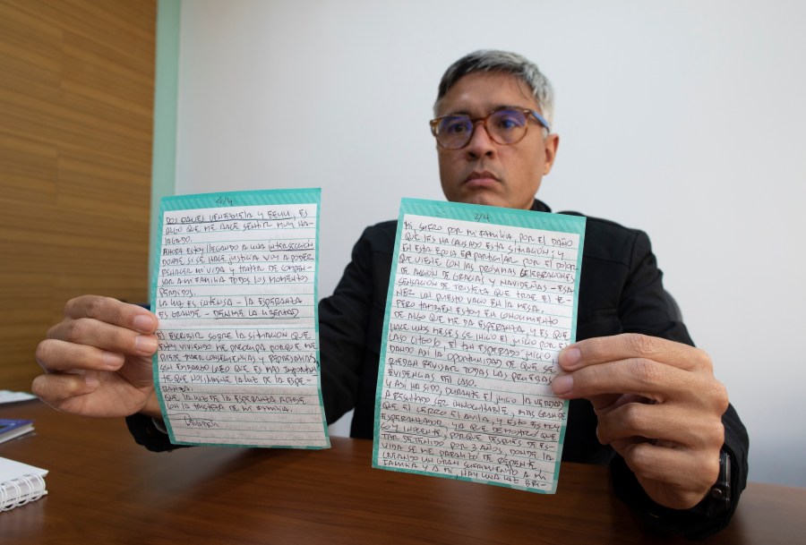 Jesus Loreto, an attorney representing Tomeu Vadell, one of six U.S. oil executives jailed for three years in Venezuela, shows a letter written by Vadell, in Caracas, Venezuela, Wednesday, Nov. 25, 2020. (Ariana Cubillos/AP Photo)