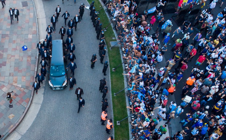 The hearse carrying the casket of Diego Maradona leaves the government house in Buenos Aires, Argentina, on Nov. 26, 2020. (Mario De Fina / Associated Press)