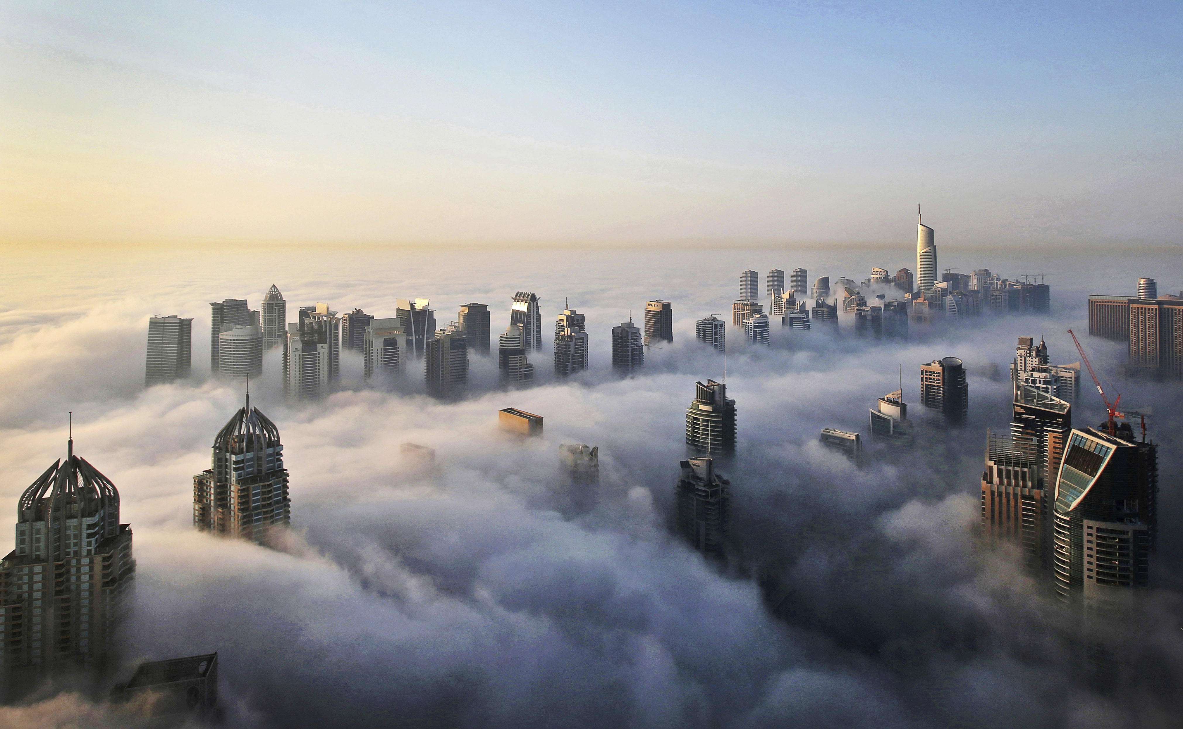 In this Monday, Oct. 5, 2015 file photo, a thick blanket of early morning fog partially shrouds the skyscrapers of the Marina and Jumeirah Lake Towers districts of Dubai, United Arab Emirates. (Kamran Jebreili/AP Photo)