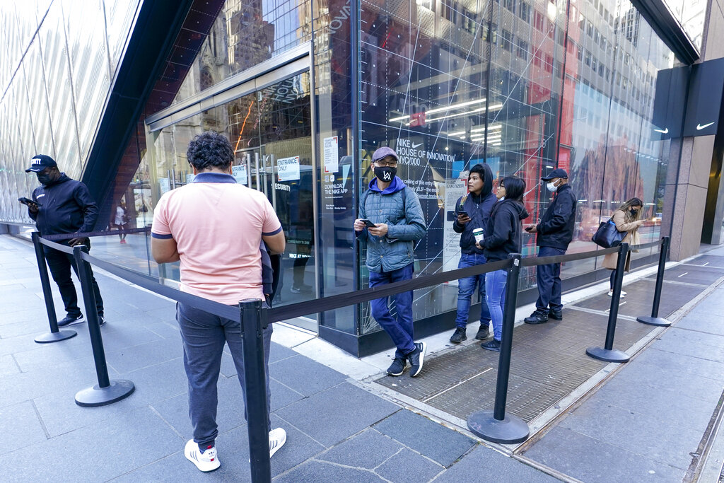 Black Friday shoppers wait in line to enter the Nike store along Fifth Avenue, Friday, Nov. 27, 2020, in New York. (AP Photo/Mary Altaffer)