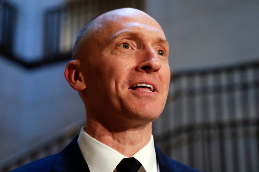 In this Nov. 2, 2017, photo, Carter Page, a foreign policy adviser to Donald Trump's 2016 presidential campaign, speaks with reporters following a day of questions from the House Intelligence Committee, on Capitol Hill in Washington. Page, who was the target of a secret surveillance warrant during the FBI’s Russia investigation says in a federal lawsuit filed Friday, Nov. 27, 2020, that he was the victim of “unlawful spying.” The suit from Carter Page alleges a series of omissions and errors made by FBI and Justice Department officials in applications they submitted to the Foreign Intelligence Surveillance Court to eavesdrop on Page on suspicion that he was an agent of Russia. (AP Photo/J. Scott Applewhite)