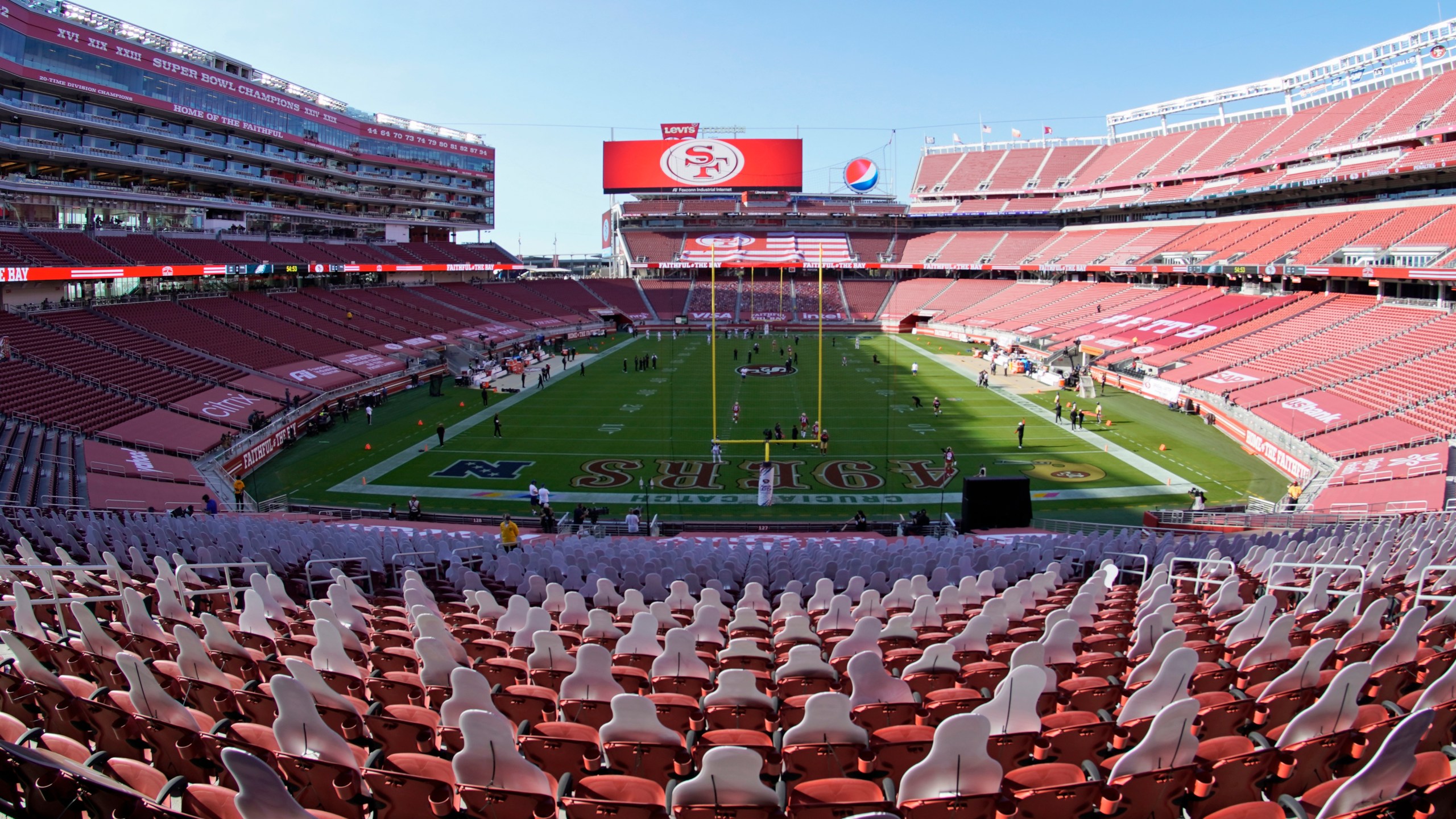 This Oct. 4, 2020, file photo, taken with a fisheye lens, shows an empty Levi's Stadium before an NFL football game between the San Francisco 49ers and the Philadelphia Eagles in Santa Clara, Calif. The 49ers and other teams may need to find a temporary new home after Santa Clara County on Nov. 28, 2020, banned all contact sports from holding games and practices for the next three weeks. County officials issued the directives in response to rising cases of the coronavirus in the area. The rules take effect Monday and will last for three weeks. (AP Photo/Tony Avelar, File)