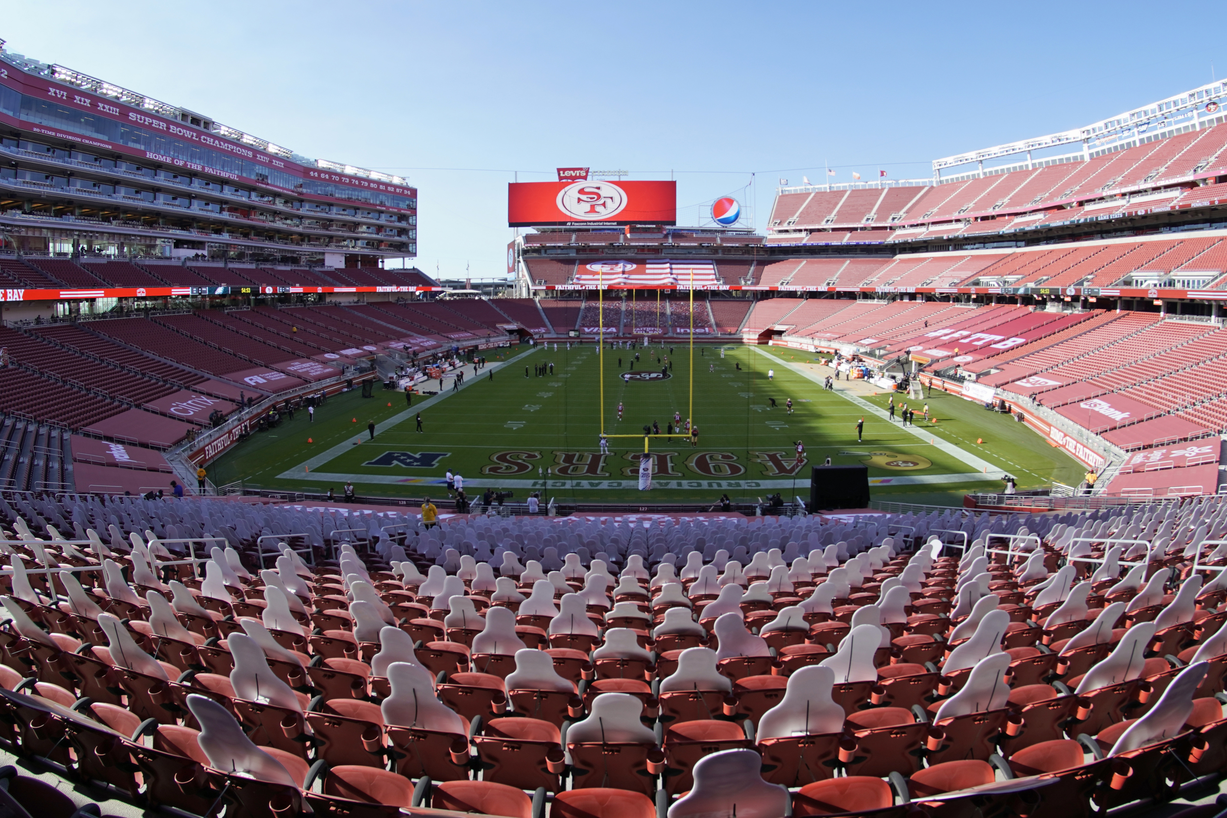 This Oct. 4, 2020, file photo, taken with a fisheye lens, shows an empty Levi's Stadium before an NFL football game between the San Francisco 49ers and the Philadelphia Eagles in Santa Clara, Calif. The 49ers and other teams may need to find a temporary new home after Santa Clara County on Nov. 28, 2020, banned all contact sports from holding games and practices for the next three weeks. County officials issued the directives in response to rising cases of the coronavirus in the area. The rules take effect Monday and will last for three weeks. (AP Photo/Tony Avelar, File)