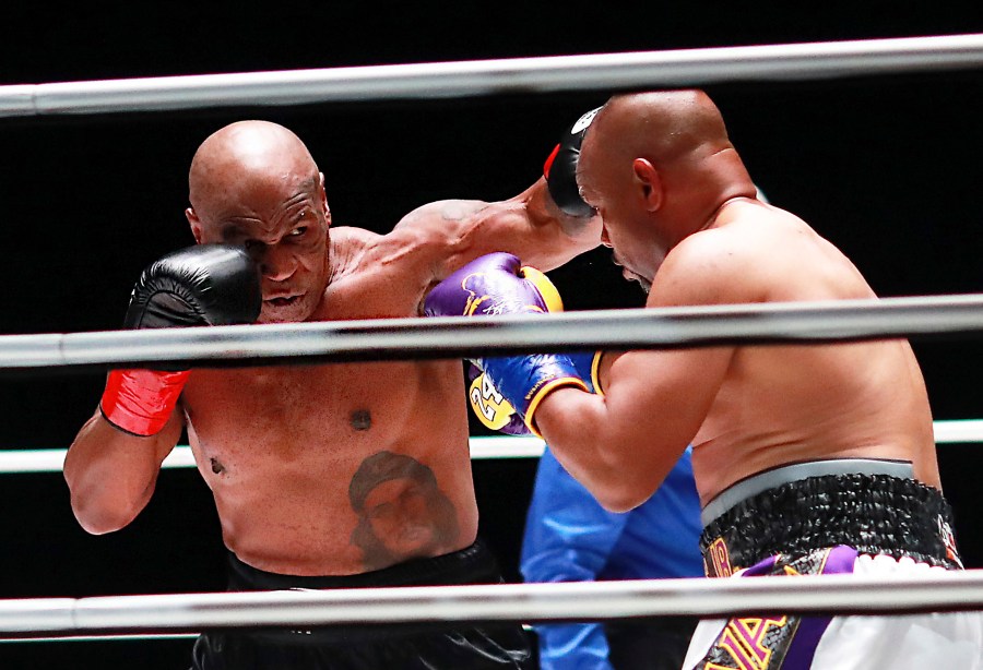 In a photo provided by Triller, Mike Tyson throws a punch during the third round against Roy Jones Jr. in an exhibition boxing bout Saturday, Nov. 28, 2020, in Los Angeles. (Joe Scarnici/Triller via AP)