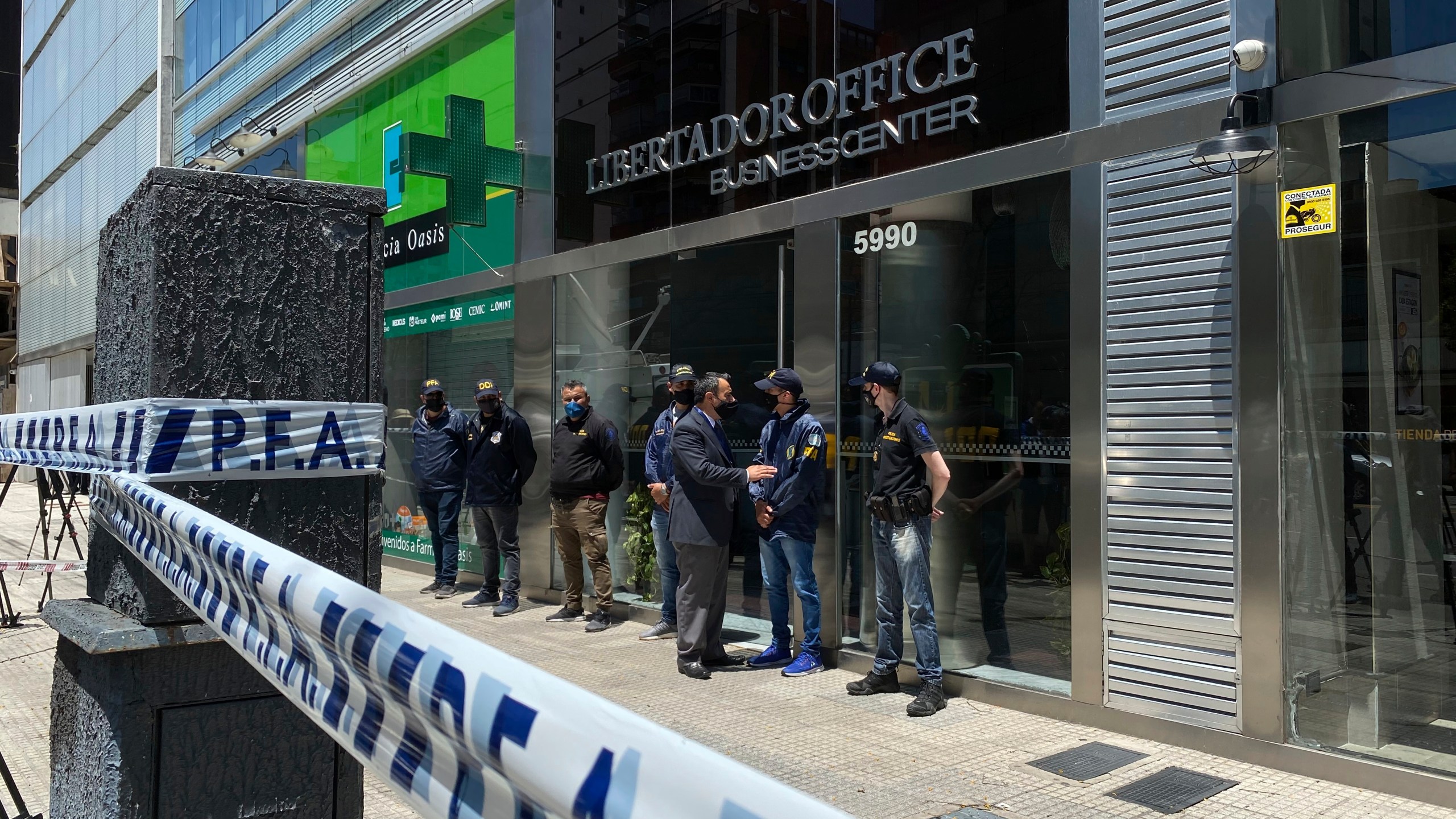 Police guard the entrance to Dr. Leopoldo Luque's practice in Buenos Aires, Argentina, Sunday, Nov. 29, 2020. Luque was Diego Maradona's personal doctor, and his house and offices were raided Sunday in the midst of investigations to establish the circumstances of Maradona's death. (AP Photo/Leo La Valle)