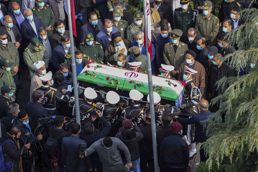 In this photo released by the official website of the Iranian Defense Ministry, military personnel carry the flag draped coffin of Mohsen Fakhrizadeh, a scientist who was killed on Friday. (Iranian Defense Ministry via AP)