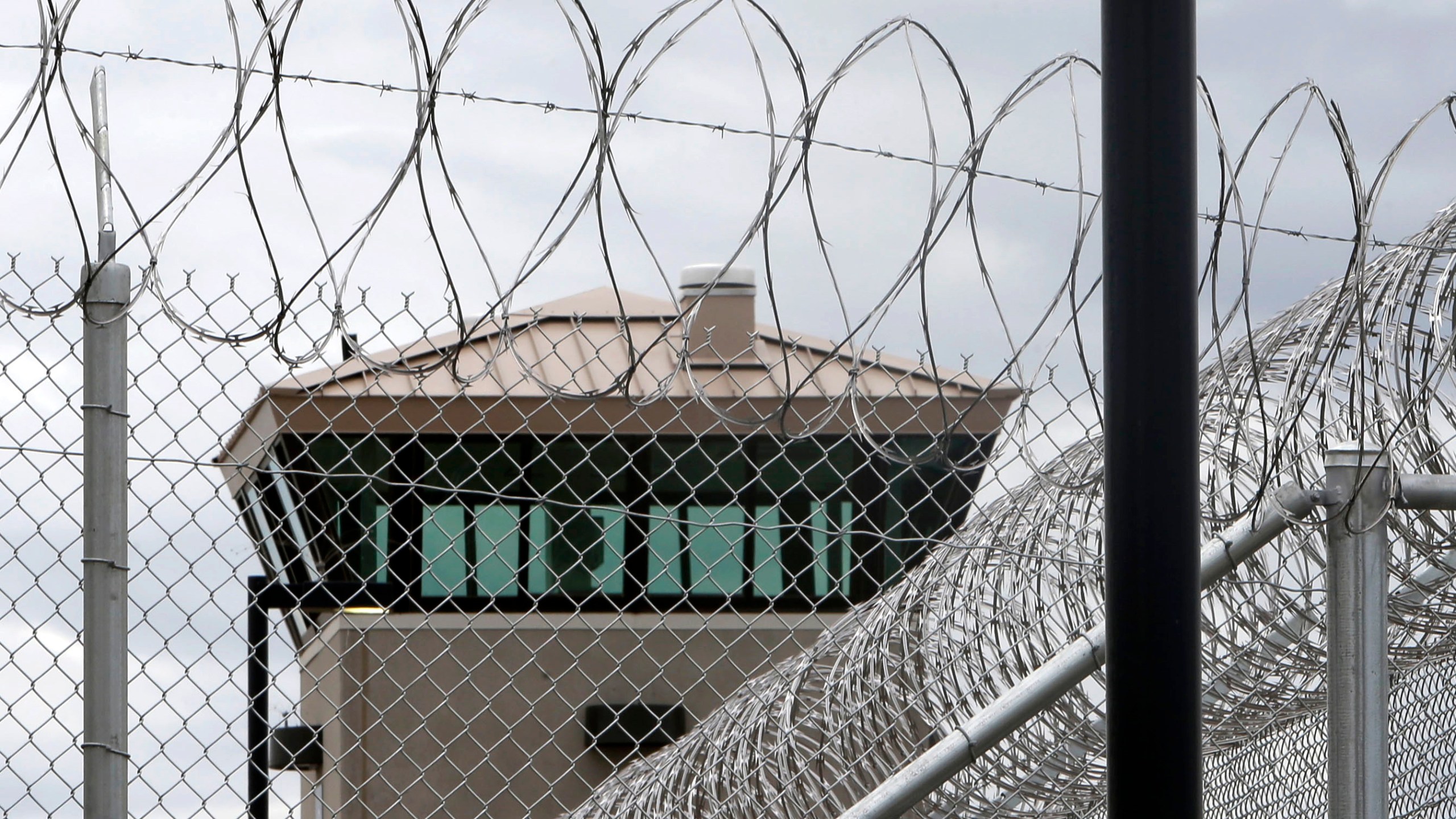 This June 25, 2013 file photo shows a guard tower over the fence surrounding the new California Correctional Health Care Facility in Stockton, Calif. (AP Photo/Rich Pedroncelli,File)