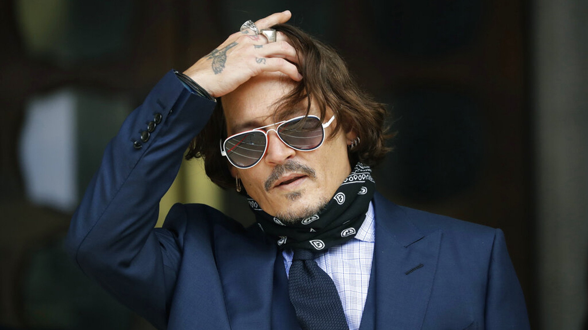 In this Tuesday, July 14, 2020 file photo, American actor Johnny Depp gestures to the media as he arrives at the High Court in London. (AP Photo/Matt Dunham, file)