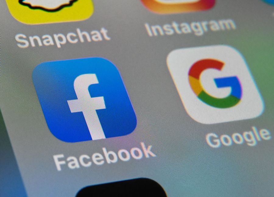 A picture taken on October 1, 2019 in Lille shows the logos of mobile apps Facebook and Google displayed on a tablet. (Denis Charlet/ AFP via Getty Images)