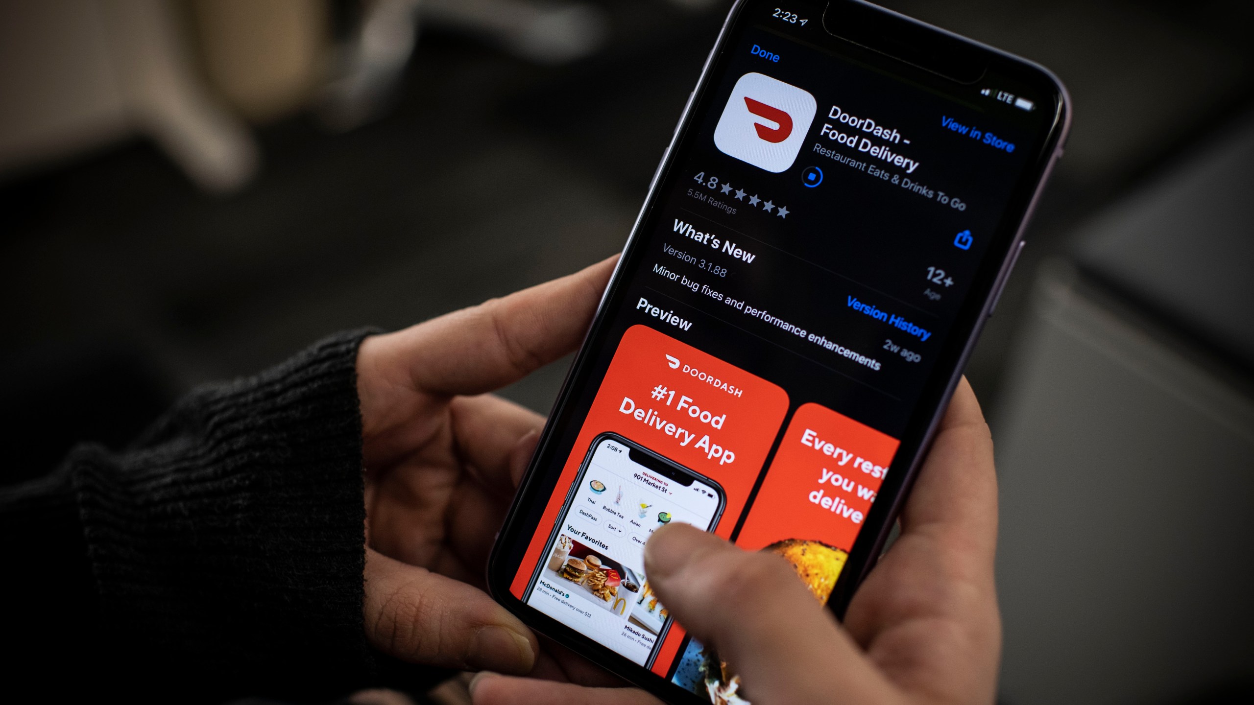 An AFP journalist checks the DoorDash food delivery application on her smartphone on Feb. 27, 2020, in Washington, D.C. (ERIC BARADAT/AFP via Getty Images)