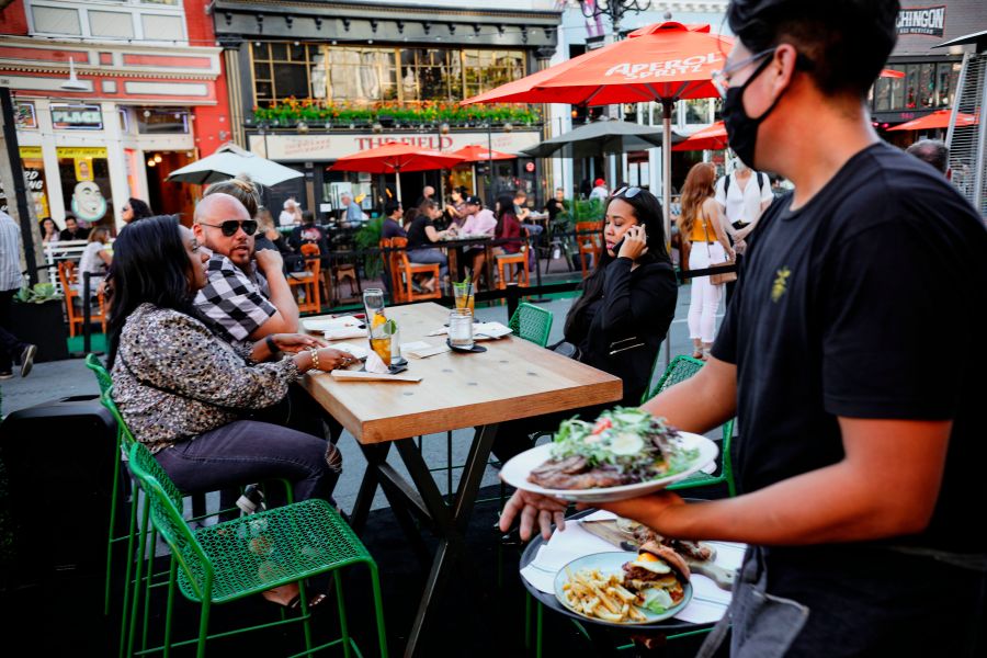 Patrons dine at an outdoor restaurant along 5th Avenue in The Gaslamp Quarter in downtown San Diego, California on, July 17, 2020. (Sandy Huffaker/AFP via Getty Images)