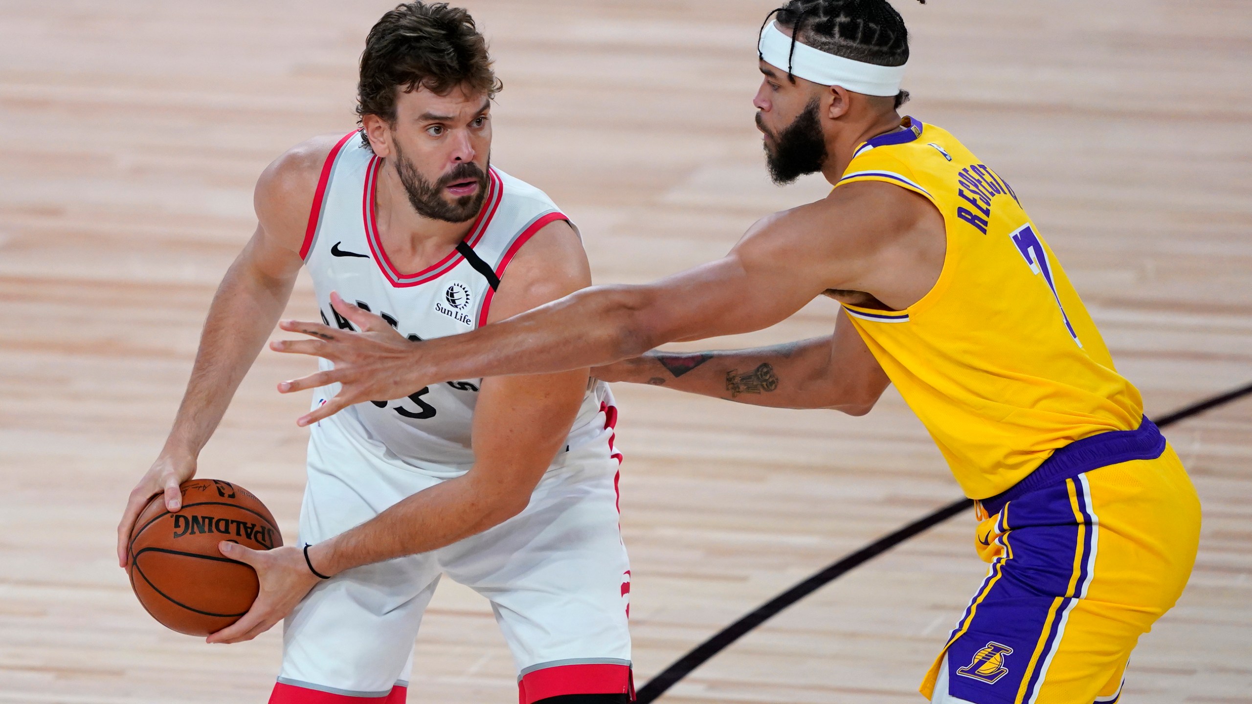 Marc Gasol holds the ball against JaVale McGee during the second half of an NBA basketball game between the Toronto Raptors and the L.A. Lakers at The Arena in the ESPN Wide World Of Sports Complex on Aug. 1, 2020 in Lake Buena Vista, Florida. (Ashley Landis - Pool/Getty Images)