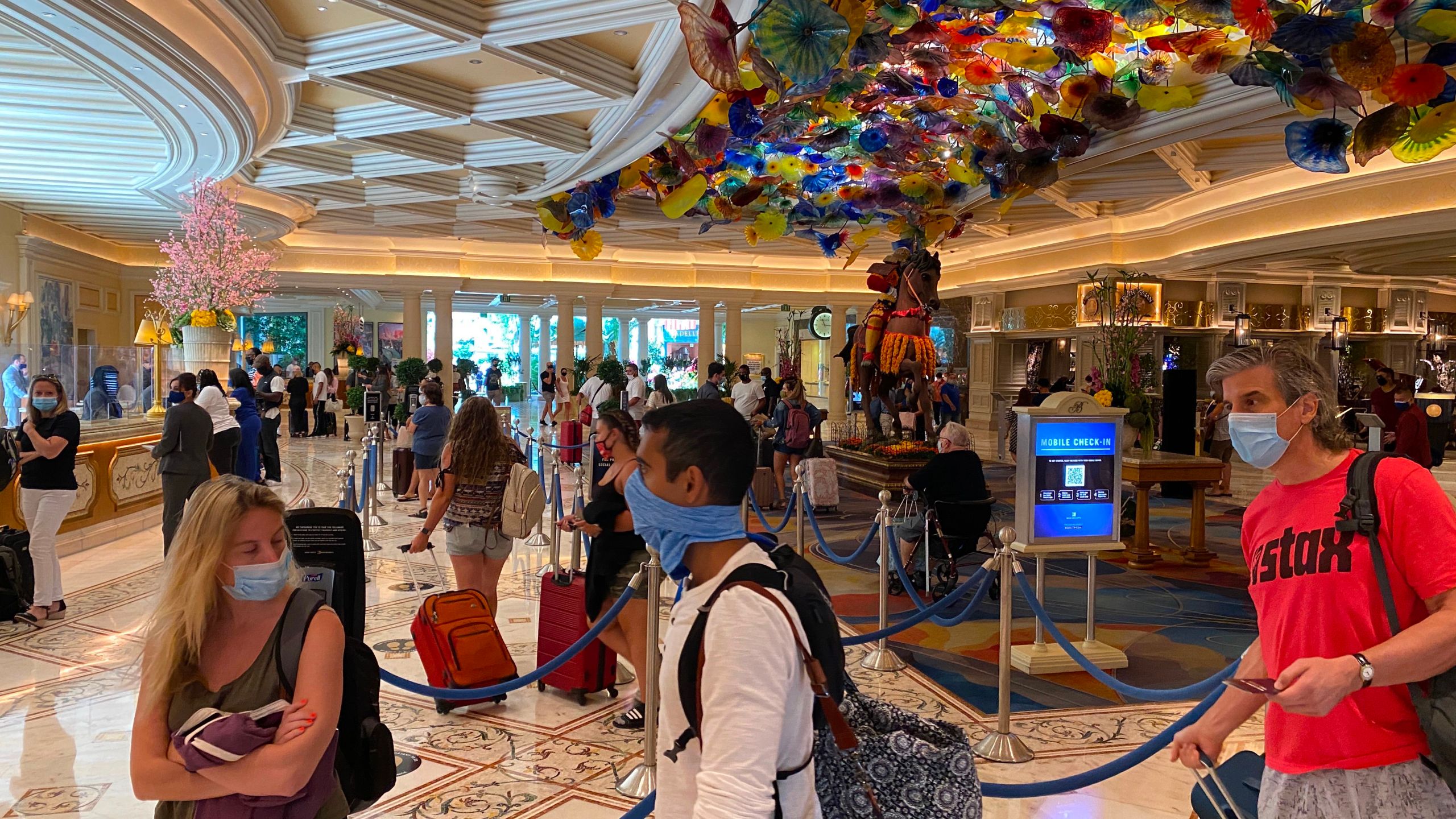 Tourists are wearing a mandatory mask as they wait to check-in at the Bellagio hotel and casino in Las Vegas, Nevada, on Aug. 28, 2020 . (DANIEL SLIM/AFP via Getty Images)