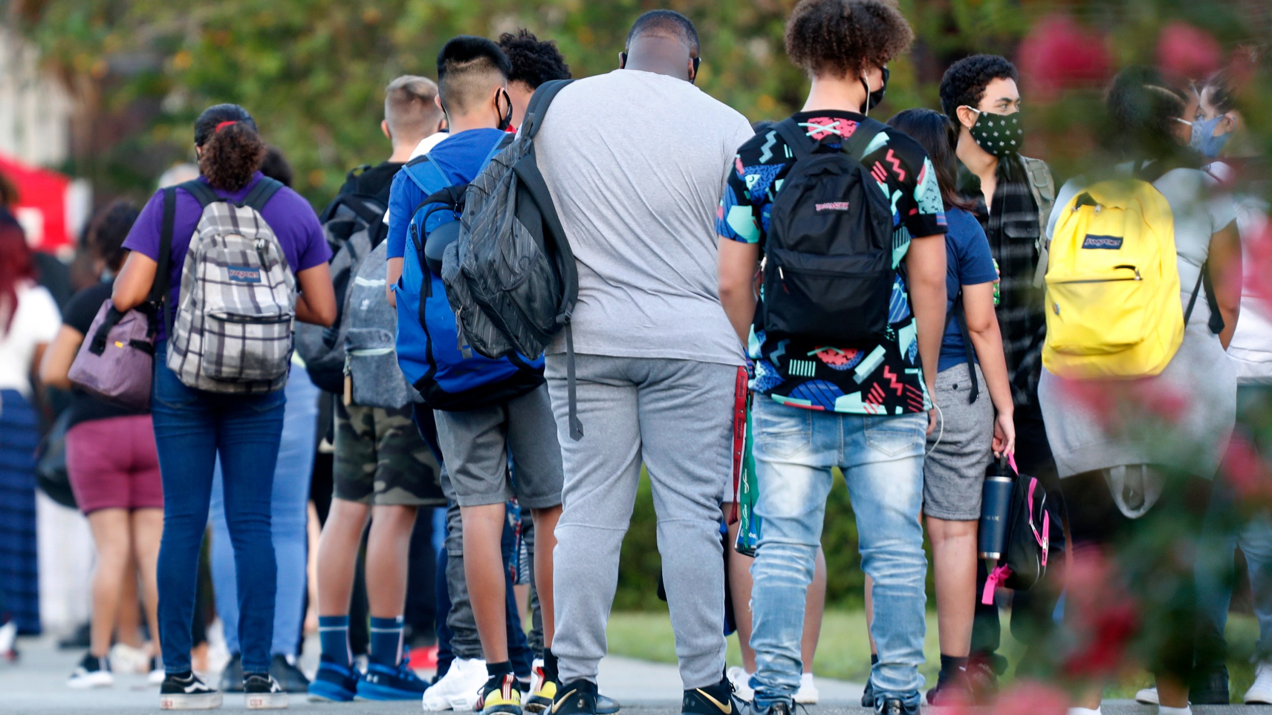 Students at Hillsborough High School in Tampa wait in line to have their temperature checked before entering the building on Aug. 31, 2020. (Octavio Jones / Getty Images)