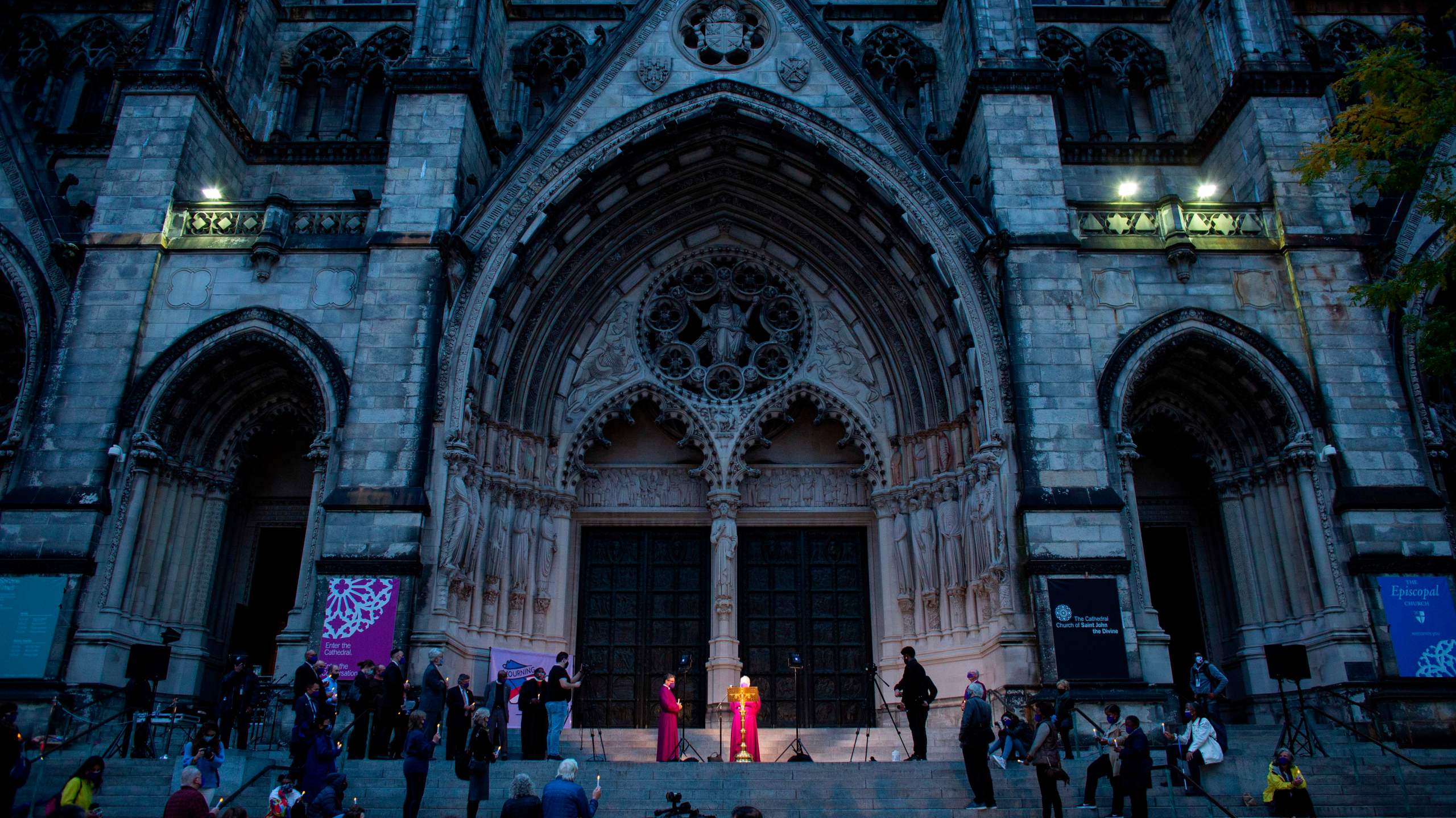 People attend a candlelight vigil a procession in tribute to all of the lives affected by the novel coronavirus outside The Cathedral of St. John the Divine in New York City on Oct. 19, 2020. (Kena Betancur / AFP / Getty Images)