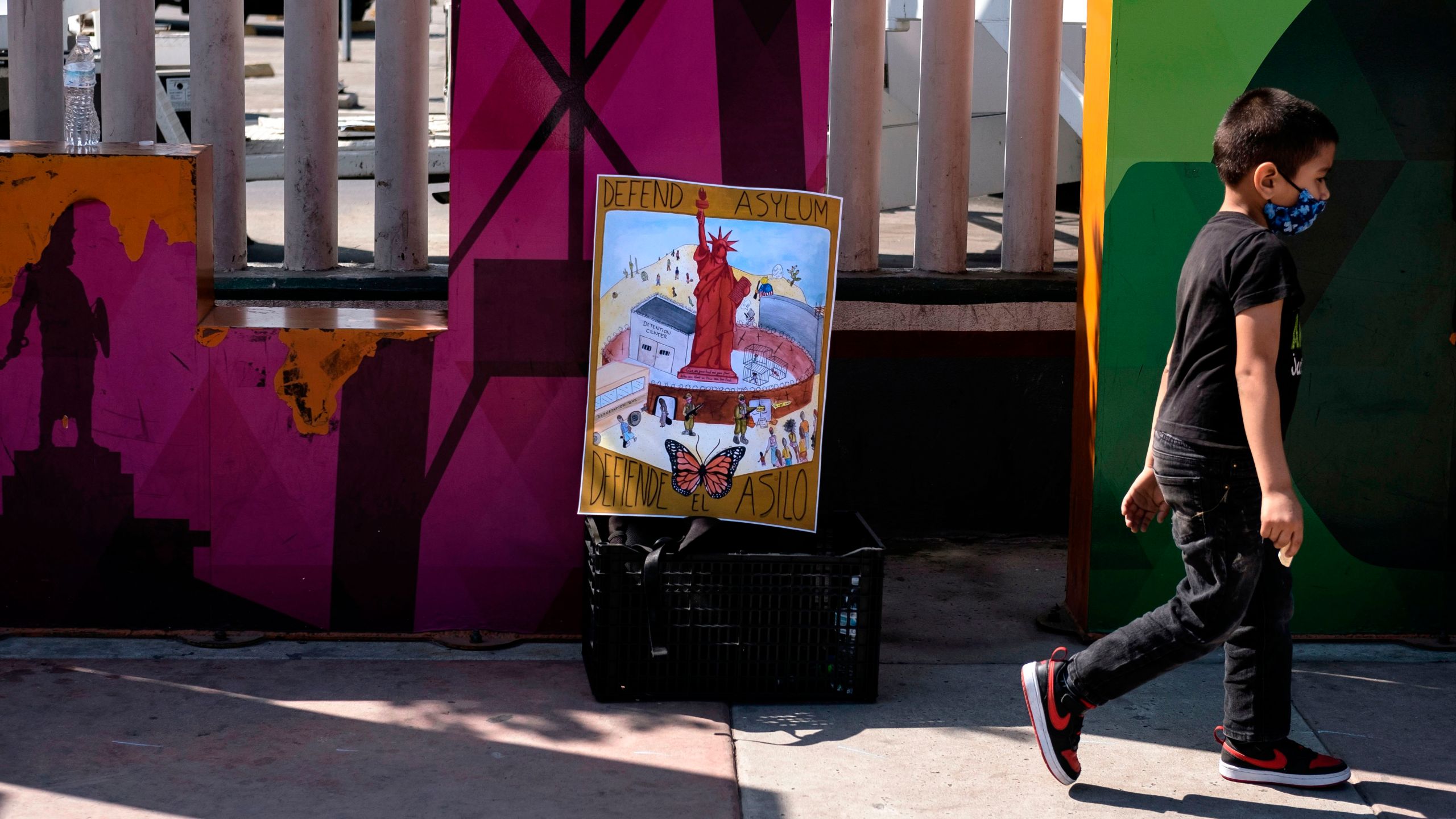 A child takes part in a protest of migrants and human rights activists against U.S. and Mexican migration policies at the San Ysidro crossing port, in Tijuana, Baja California state, Mexico, on the border with the U.S., on Oct. 21, 2020, amid the new coronavirus pandemic. (GUILLERMO ARIAS/AFP via Getty Images)