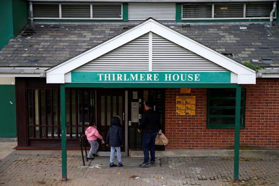 Dom Palacio, Head of Community at Richmond Rugby, delivers meals to local school children living in a block of flats on the Ivybridge estate in Twickenham, south west London, on Oct. 26, 2020, following the British Government's announcement not extend free school meals for children during the school holidays and periods of lockdown. (HOLLIE ADAMS/AFP via Getty Images)