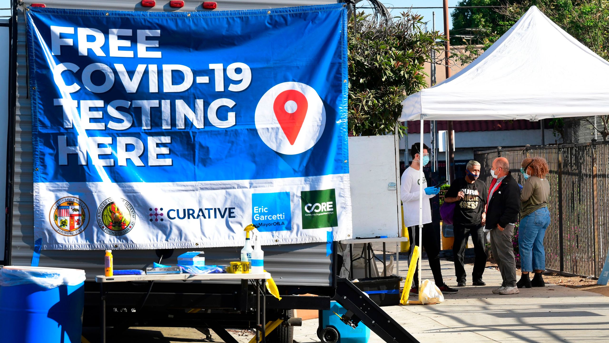 People check-in at a pop-up COVID-19 Test site in Los Angeles on October 29, 2020, where the testing is walk-up only with no appointments necessary and results in 48 hours. (Photo by Frederic J. Brown/AFP via Getty Images)