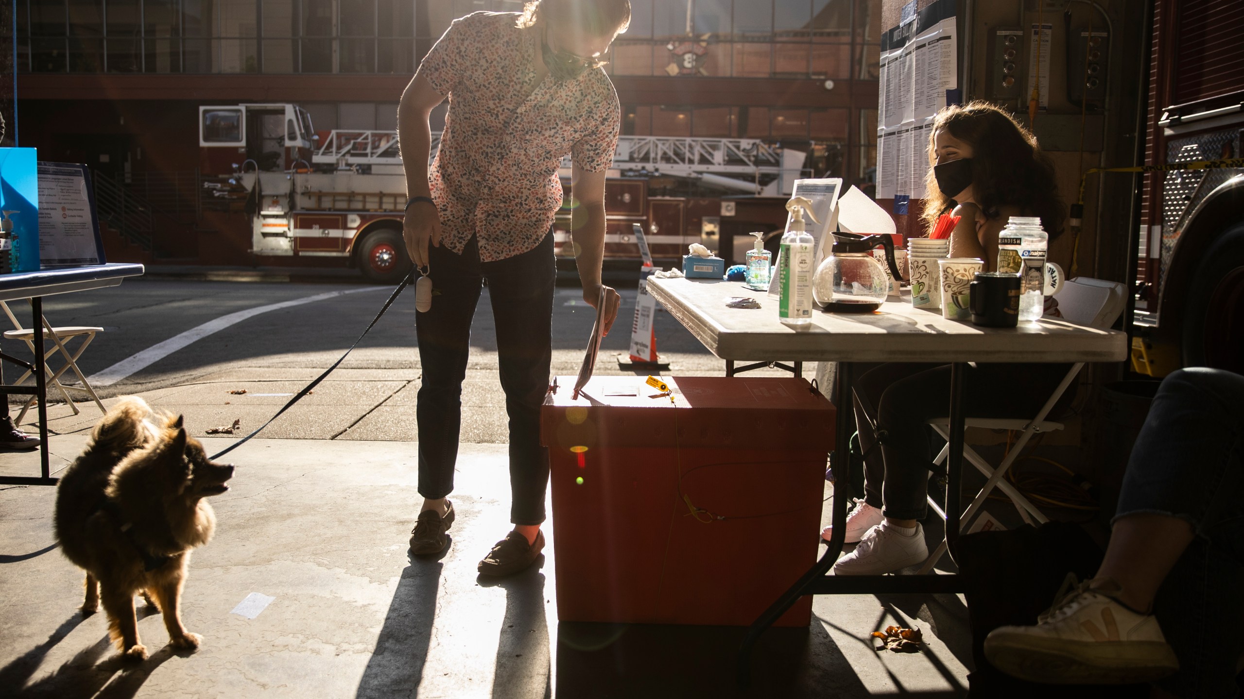 A voter casts a mail-in ballot at a polling station inside a San Francisco firehouse on Nov. 3, 2020. (Stephen Lam / Getty Images)