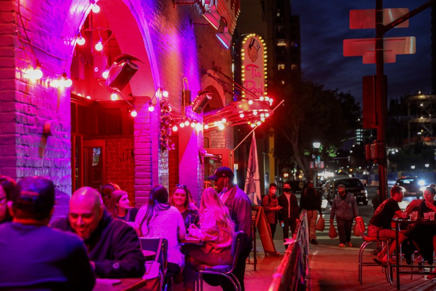 People dine along 5th Avenue in the Gaslamp Quarter before an imposed curfew on Nov. 21, 2020 in San Diego. California Governor Gavin Newsom has imposed a curfew, starting at 10 p.m. Saturday evening, affecting most California counties due to an increase of COVID-19 infection rates around the state. (Sandy Huffaker/Getty Images)