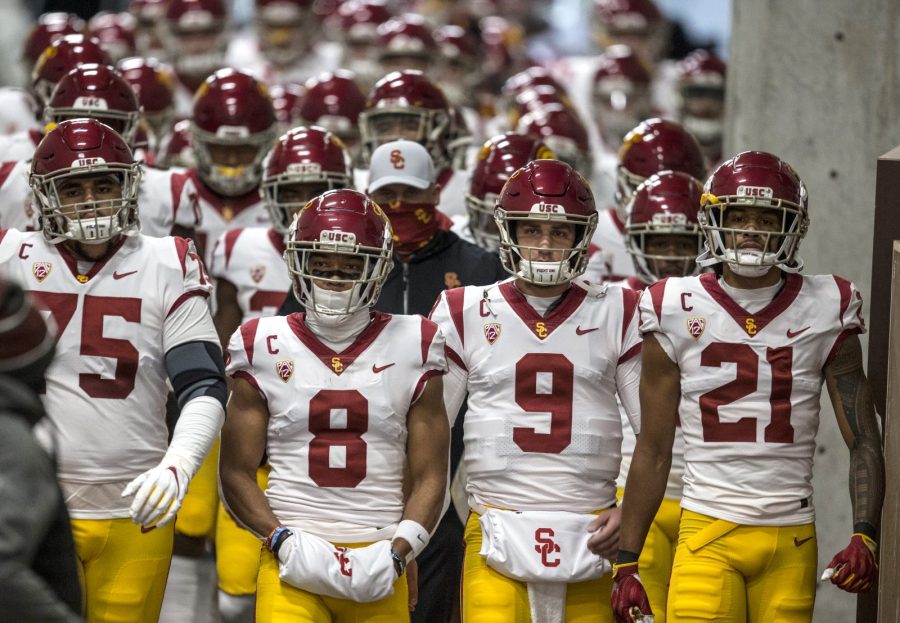 Alijah Vera-Tucker #75, Amon-Ra St. Brown #8, Kedon Slovis #9 and Tyler Vaughns #21 of the USC Trojans lead their team down the tunnel to the field before the start of their game against the Utah Utes November 21, 2020 at Rice Eccles Stadium in Salt Lake City, Utah. (Chris Gardner/Getty Images)