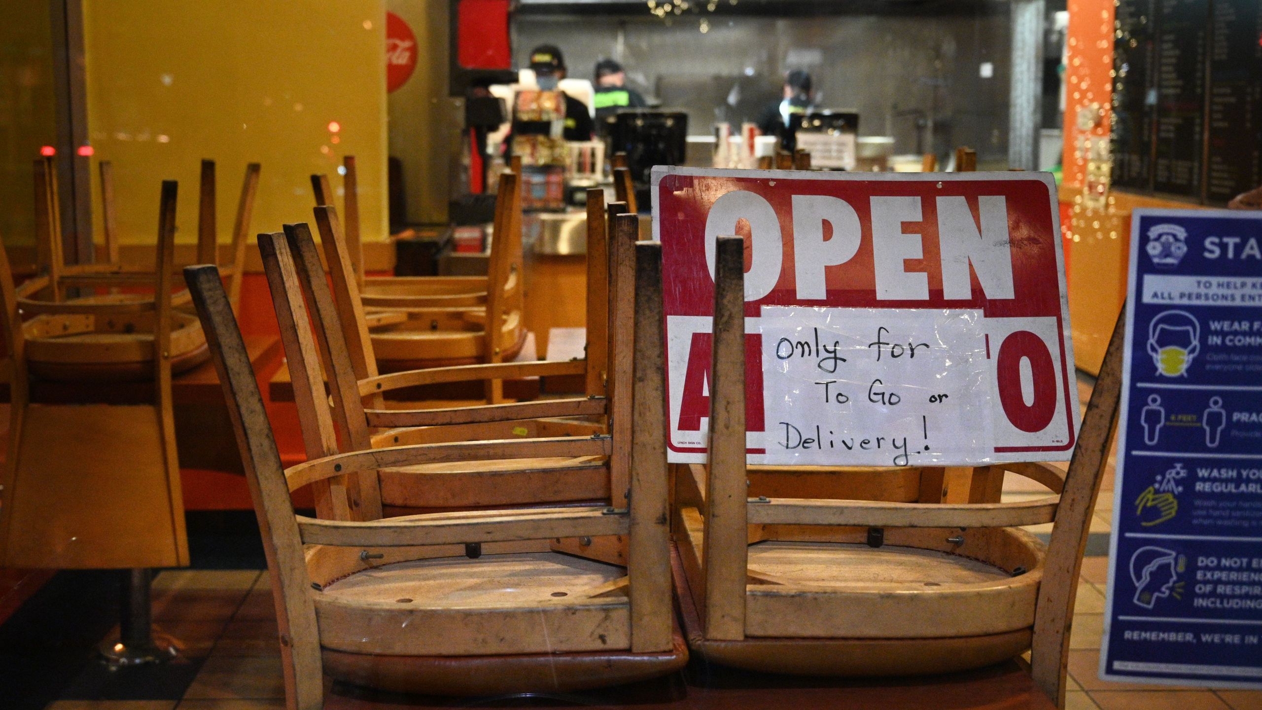 Employees work in a restaurant open for to-go or delivery orders only, in Burbank on Nov. 23, 2020. (ROBYN BECK/AFP via Getty Images)