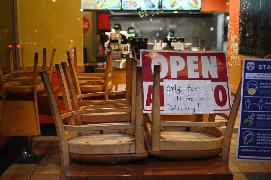 Employees work in a restaurant open for to-go or delivery orders only, in Burbank on Nov. 23, 2020. (ROBYN BECK/AFP via Getty Images)