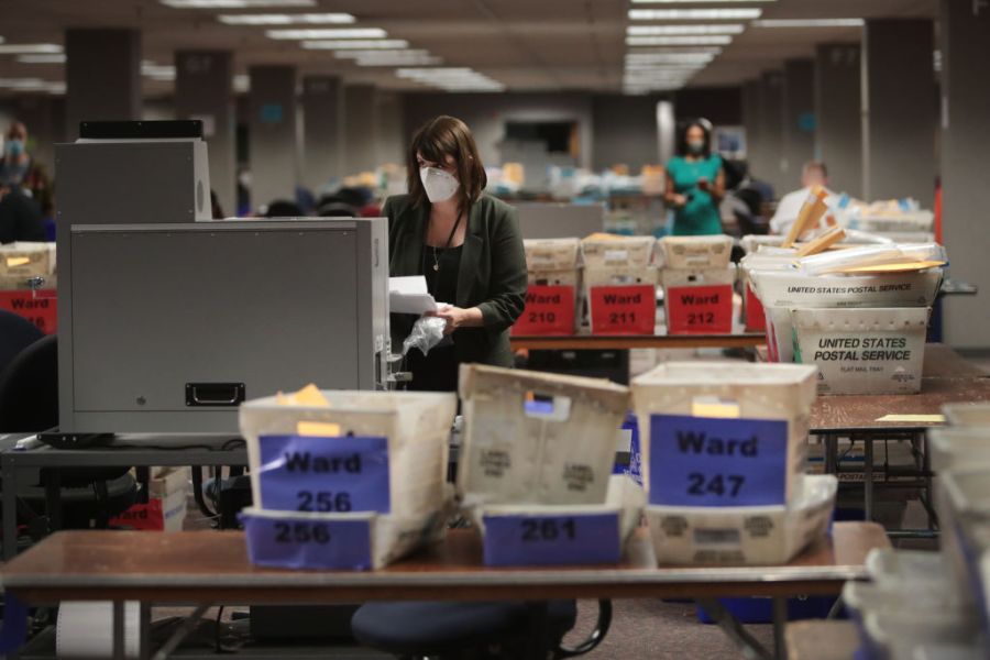 Claire Woodall-Vogg, executive director of the Milwaukee election commission, collects the count from absentee ballots from a voting machine on November 04, 2020 in Milwaukee. Wisconsin requires election officials to wait to begin counting absentee ballots until after polls open on election day.(Scott Olson/Getty Images)