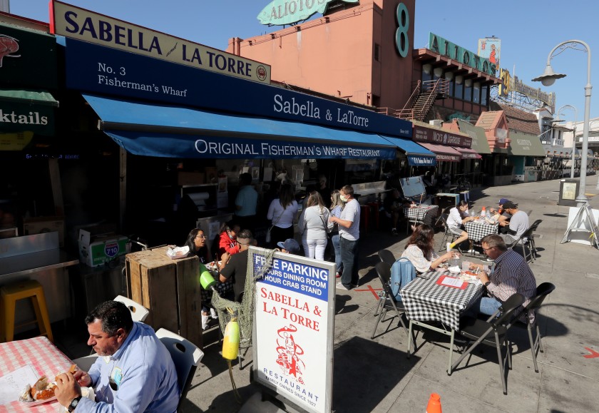 Sitting outdoors, customers dine at Fishermen’s Wharf in San Francisco on Friday, Aug. 23, 2020. (Luis Sinco/Los Angeles Times)