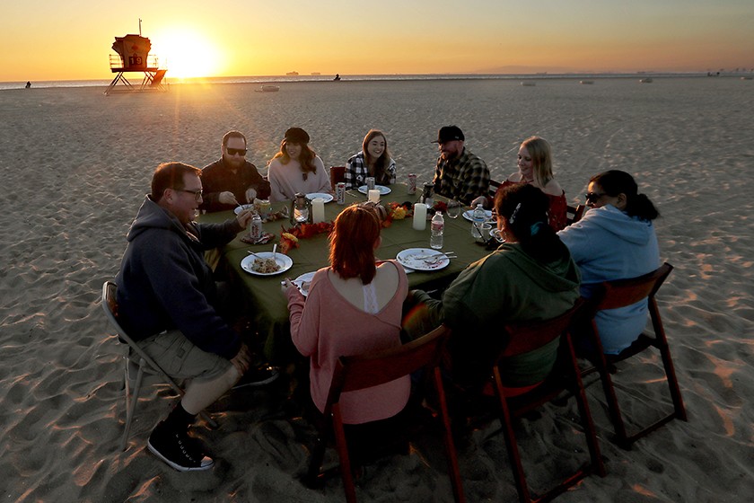 Members of the Hobbs-Brown family dine on the sand at Bolsa Chica State Beach.(Luis Sinco / Los Angeles Times)