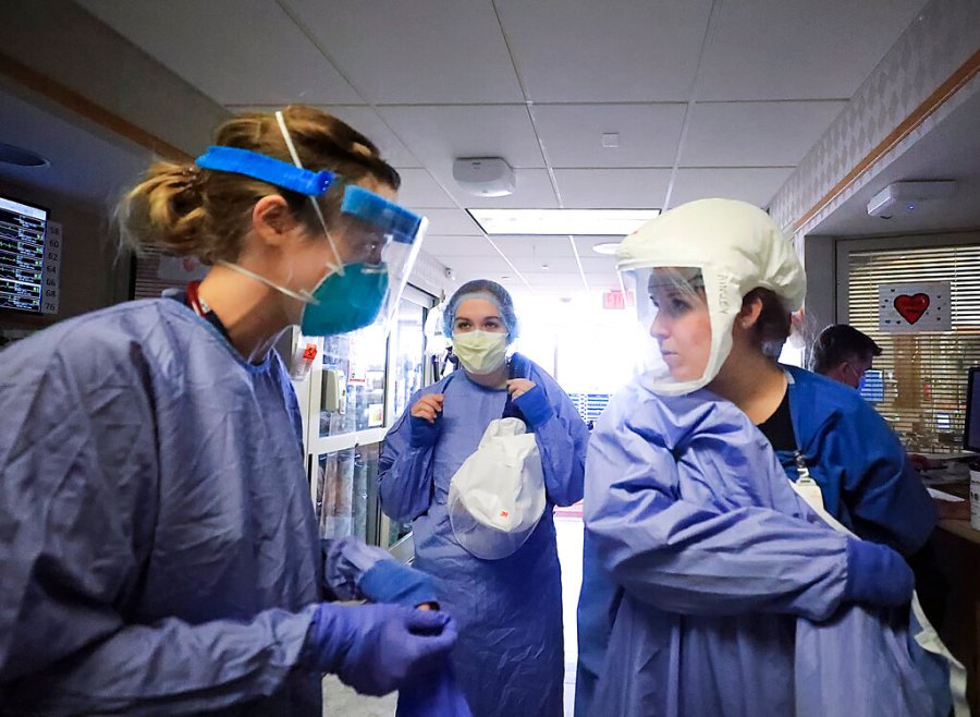 Medical staff attending to patients with COVID-19 wear protective equipment in a unit dedicated to treatment of the coronavirus at UW Health in Madison, Wis. (John Hart/Wisconsin State Journal via AP, File)