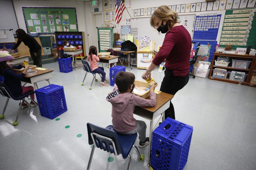 A kindergarten teacher collects crayons from students in her classroom at Lupin Hill Elementary School in Calabasas on Nov. 9, 2020. (Al Seib / Los Angeles Times)