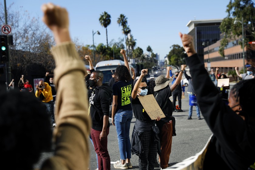 Demonstrators stop traffic near Los Angeles Mayor Eric Garcetti’s home in Windsor Square on Nov. 30, 2020, the seventh consecutive day of protests there. (Christina House / Los Angeles Times)