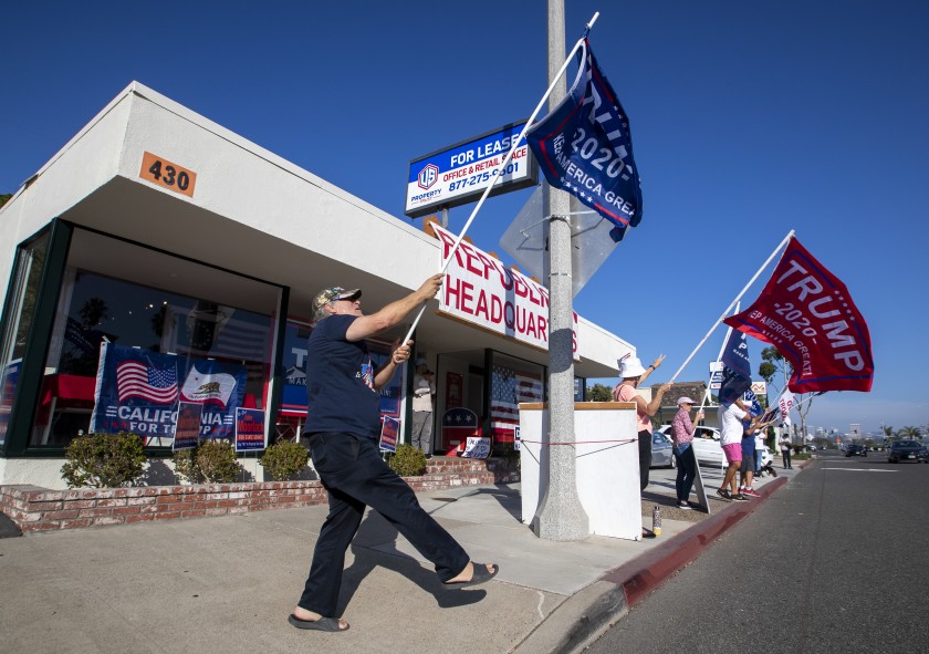 Trump supporters shout to passing motorists in front of GOP headquarters on Nov. 3, 2020 in Newport Beach. (Allen J. Schaben/Los Angeles Times)