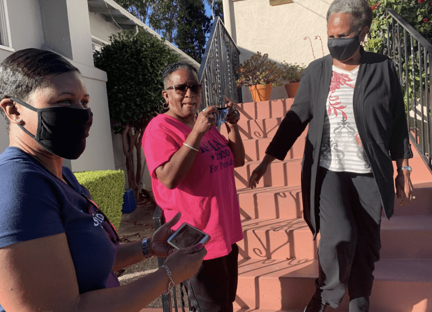 From left: Saniyyah Smith, Sharon McGaffie and Judy Robinson stand on the steps of McGaffie’s and Robinson’s mother’s home in November 2020. They grew up two doors down from vice president-elect Kamala Harris. (Susanne Rust/Los Angeles Times)