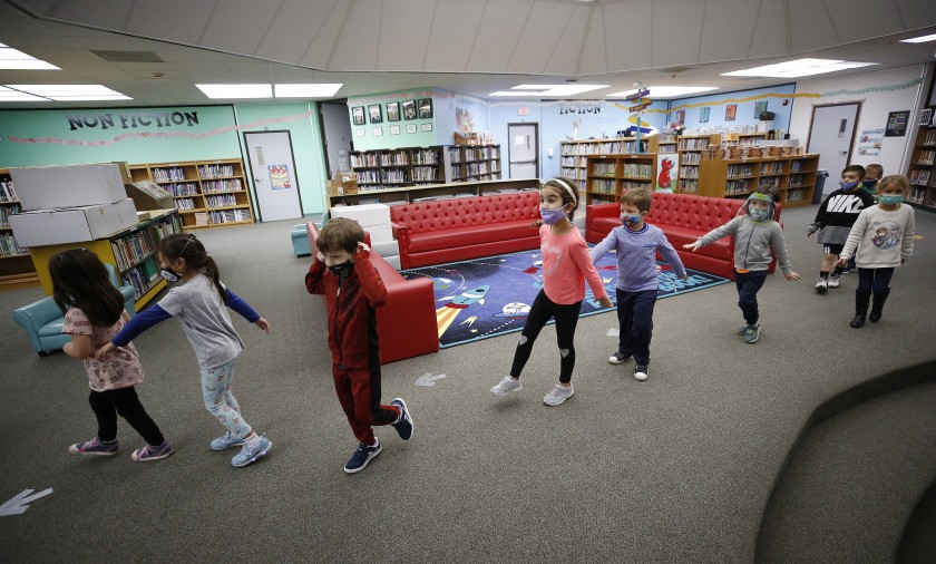 Kindergarteners at Lupin Hill Elementary School in Calabasas practice social distance walking through the library on Nov. 9, 2020. (Al Seib / Los Angeles Times)