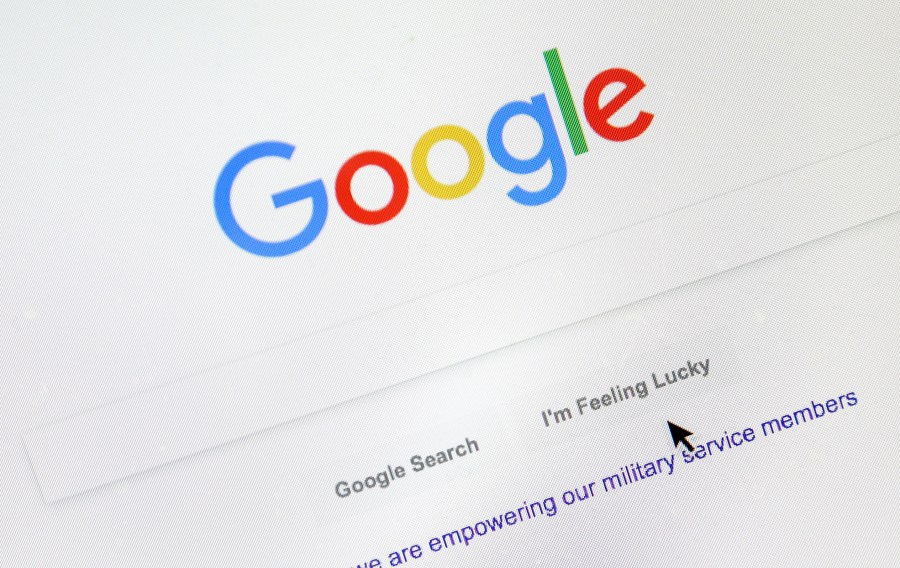 In this Aug. 28, 2018, file photo, a cursor moves over Google's search engine page, in Portland, Ore. (AP Photo/Don Ryan, File)