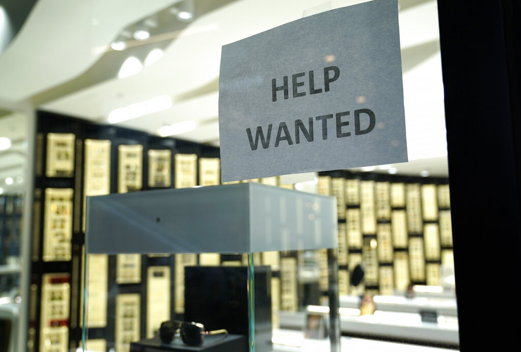 A Help Wanted sign is posted at a Designer Eyes store at Brickell City Centre, Friday, Nov. 6, 2020, in Miami. (AP Photo/Lynne Sladky)