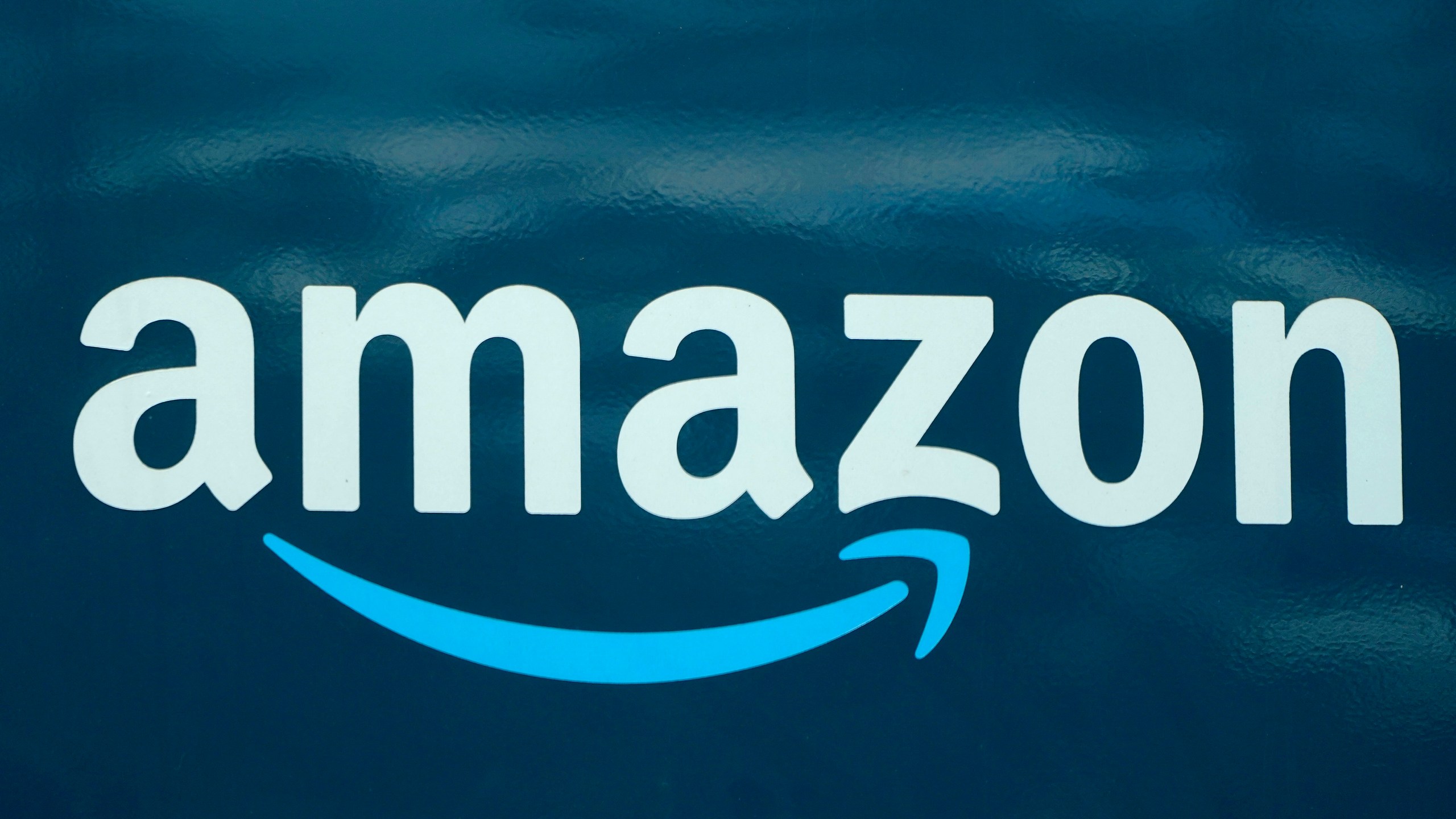 In this Oct. 1, 2020 file photo, an Amazon logo appears on an Amazon delivery van, in Boston. Amazon opened an online pharmacy Tuesday, Nov. 17 giving shoppers the chance to buy their medication and order refills on their phones and computers and have it delivered to their doorsteps in a couple of days. (AP Photo/Steven Senne, File)