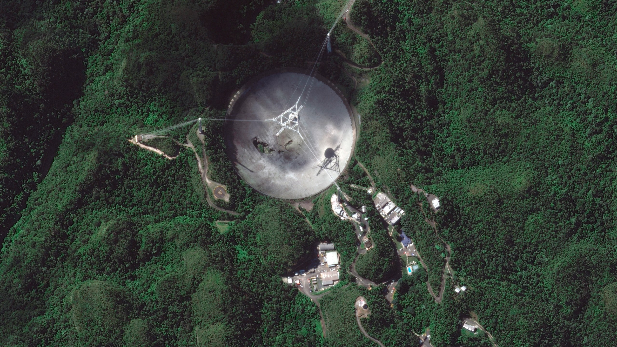 This satellite image provided by 2020 Maxar Technologies shows the damaged radio telescope at the Arecibo Observatory in Puerto Rico, Thursday, Nov. 17, 2020. (Satellite image ©2020 Maxar Technologies via AP)