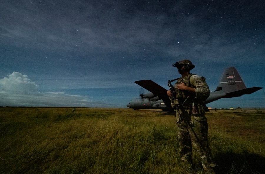 U.S. Army Spc. Kevin Martin, junior sniper, assigned to the 1-186th Infantry Battalion, Task Force Guardian, Combined Joint Task Force - Horn of Africa, provides security for a 75th Expeditionary Airlift Squadron (EAS) C-130J Super Hercules during unloading operations at an unidentified location in Somalia Sunday, June 28, 2020. (Tech. Sgt. Christopher Ruano/Combined Joint Task Force - Horn of Africa via AP)