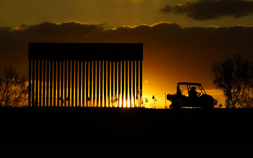 Authorities pass a border wall construction site, in Mission, Texas, Monday, Nov. 16, 2020. (AP Photo/Eric Gay)