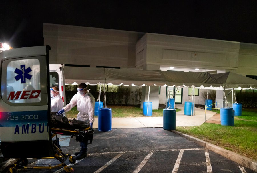 In this Dec. 1, 2020, file photo, a stretcher is loaded back into an ambulance after EMTs dropped off a patient at a newly opened field hospital operated by Care New England to handle a surge of COVID-19 patients in Cranston, R.I. (AP Photo/David Goldman)