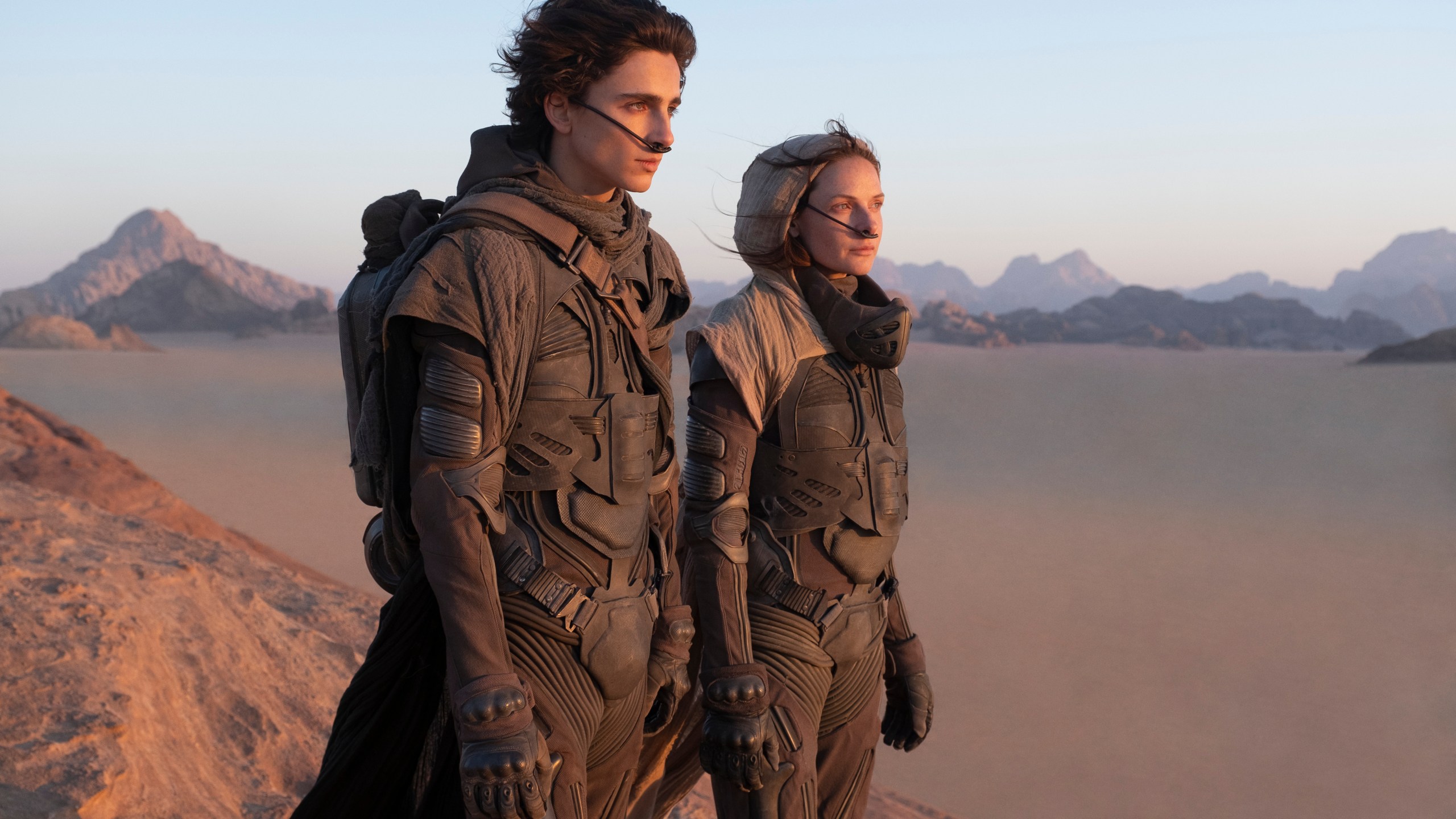 This image released by Warner Bros. Entertainment shows Timothee Chalamet, left, and Rebecca Ferguson in a scene from the upcoming 2021 film "Dune." Warner Bos. Pictures on Thursday announced that all of its 2021 film slate will stream on HBO Max at the same time they play in theaters. (Chia Bella James/Warner Bros. Entertainment via AP)