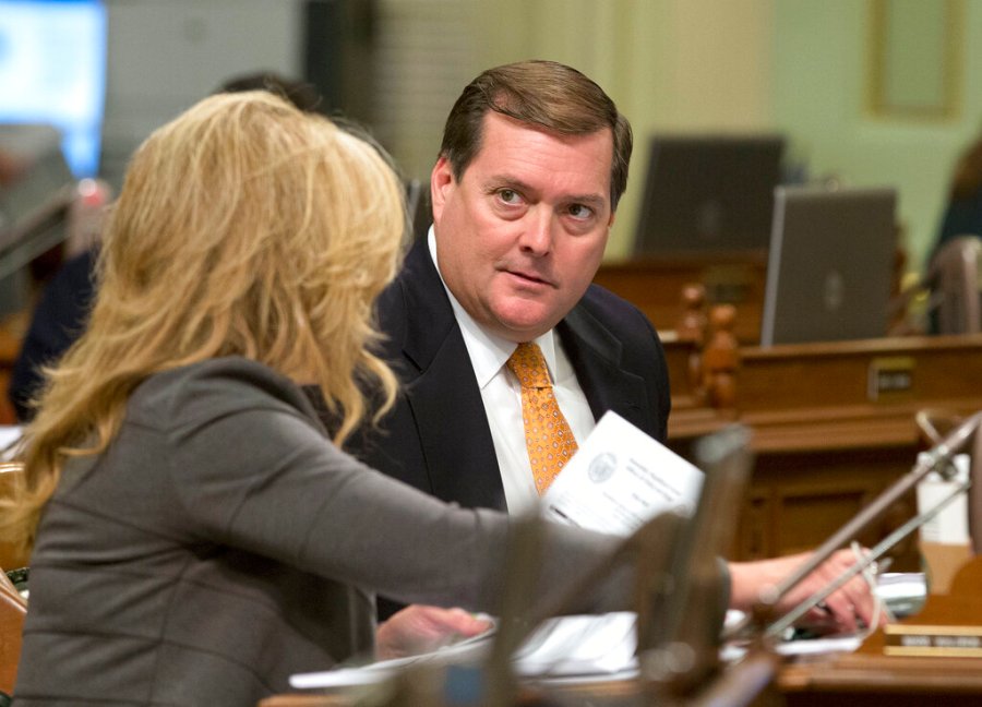 In this Aug. 30, 2016, file photo, Assemblyman Bill Brough, R-Dana Point, right, talks with Assemblywoman Marie Waldron, R-Escondido, in Sacramento, Calif. (AP Photo/Rich Pedroncelli, File)