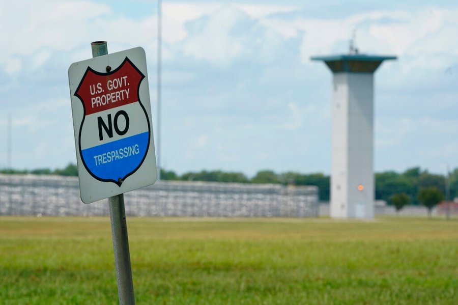 In this Aug. 28, 2020, file photo, a no trespassing sign is displayed outside the federal prison complex in Terre Haute, Ind. s after a 17-year pause. (AP Photo/Michael Conroy, File)