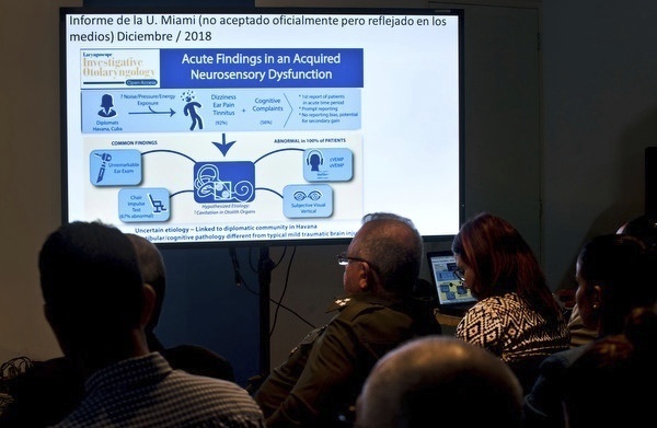 In this March 14, 2019, file photo, Cuban officials make a presentation on a series of mysterious illnesses suffered by U.S. and Canadian diplomats in Havana, reiterating that no evidence supports allegations that the symptoms resulted from high-tech attacks, during a news conference in Havana, Cuba. (Ramon Espinosa/AP Photo)