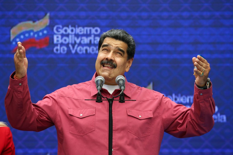 Venezuela's President Nicolas Maduro talks to journalist covering his vote in elections to choose members of the National Assembly in Caracas, Venezuela, Sunday, Dec. 6, 2020. (Ariana Cubillos/AP Photo)