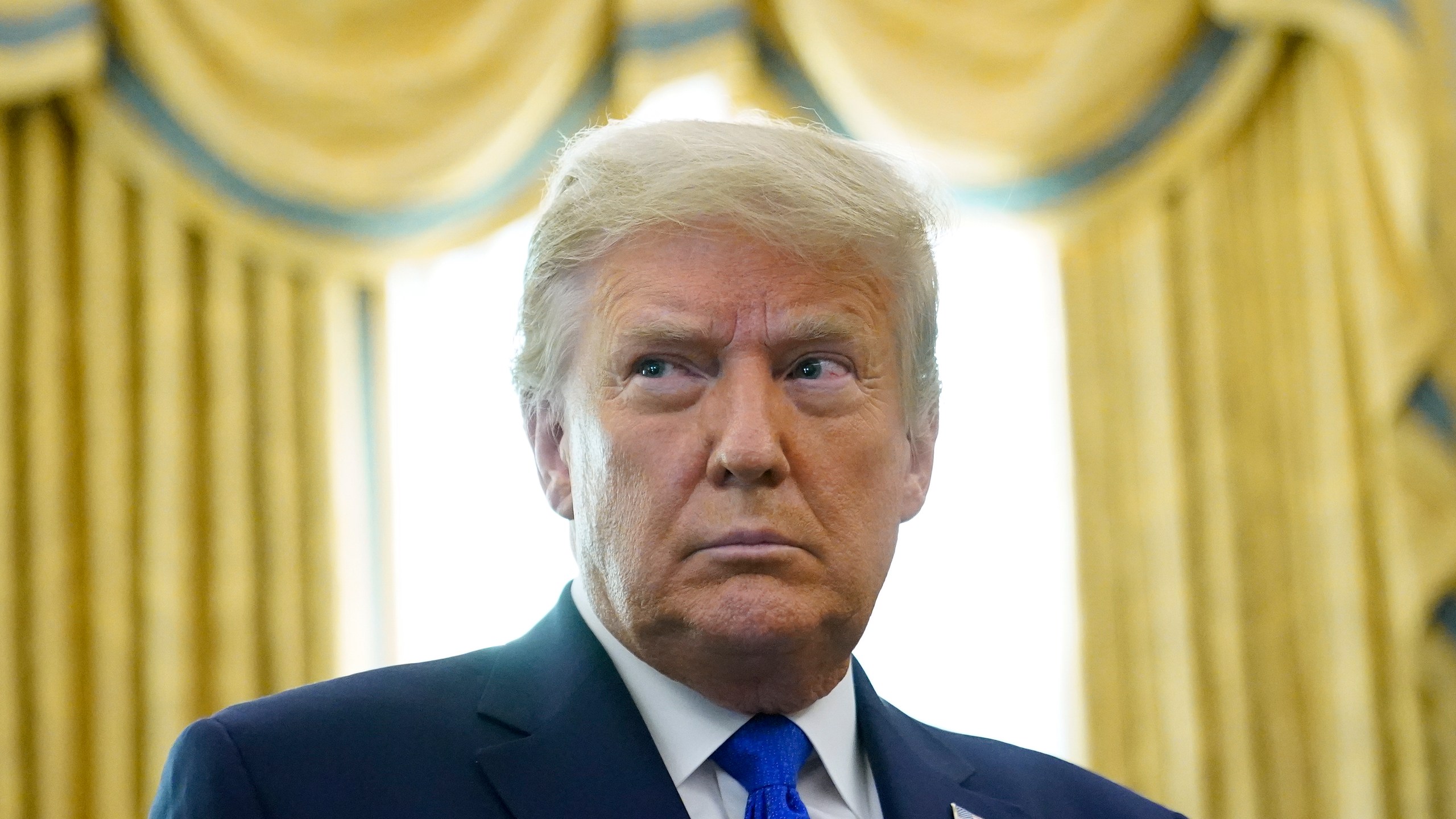 President Donald Trump prepares to award the Presidential Medal of Freedom, the highest civilian honor, to Olympic gold medalist and former University of Iowa wrestling coach Dan Gable in the Oval Office of the White House, Monday, Dec. 7, 2020, in Washington. (AP Photo/Patrick Semansky)